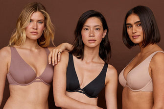 Three models, each wearing ThirdLove's Unlined Plunge Bra in a purple, black, and nude colors