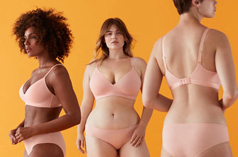 Women modeling ThirdLove's Pima Cotton Wireless Bras in a light pink color.