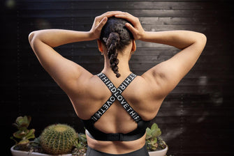 Woman wearing a sports bra that crosses in the back.