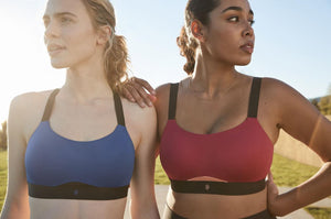 Two women wearing sports bras.