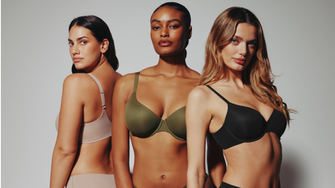 Woman choosing whether to wear a bra for breast support and comfort.