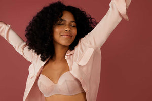 Woman dancing happily with arms up while wearing ThirdLove's Eyelash Lace Demi Bra in Atmosphere