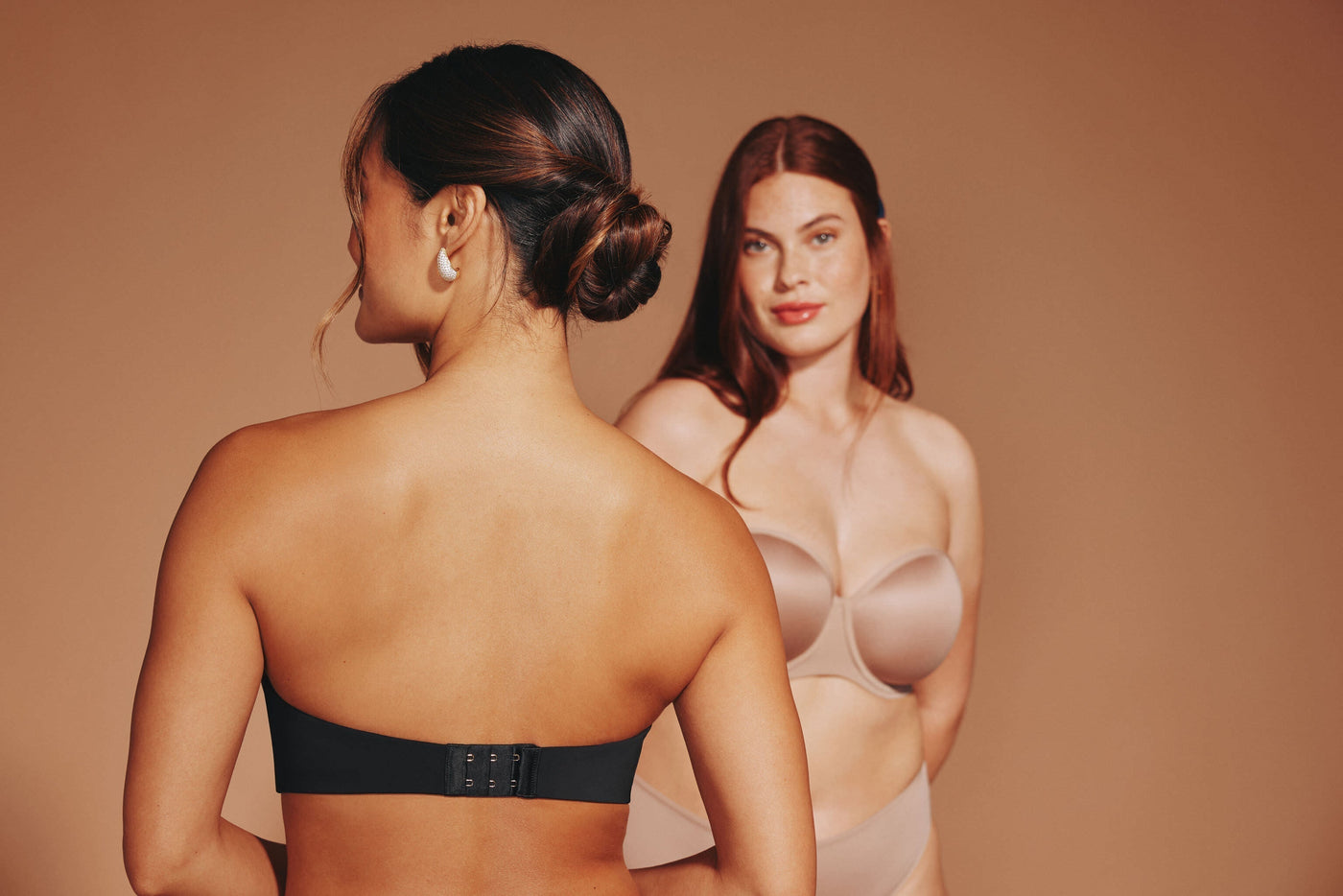 Women wearing strapless bras with halter tops, showcasing supportive options that stay hidden under the neckline.