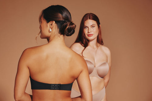 Women wearing strapless bras with halter tops, showcasing supportive options that stay hidden under the neckline.