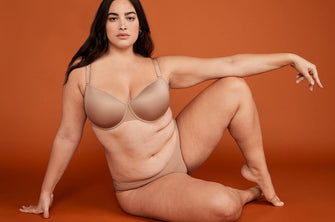 Woman modeling ThirdLove's Classic T-shirt Bra and Comfort Stretch Bikini in nude.