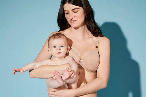 Woman holding baby while wearing ThirdLove's Classic Nursing Bra with Taupe which features removable cup.