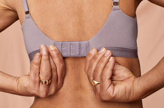Woman setting her ThirdLove bra to the loosest hook, indicating the perfect fit.