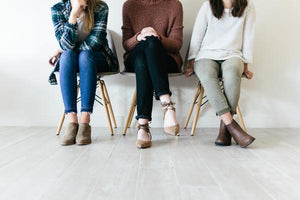 Three stylish women sitting in a bright space