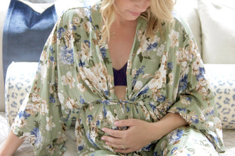 Pregnant woman wearing black t shirt bra and flower kimono